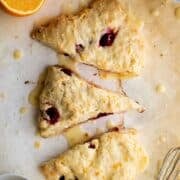 Overhead view of cranberry scones topped with glaze.