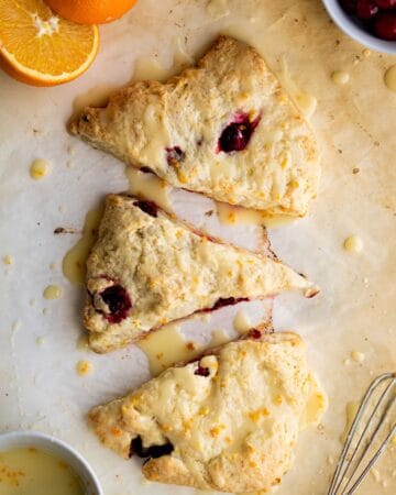 Overhead view of cranberry scones topped with glaze.