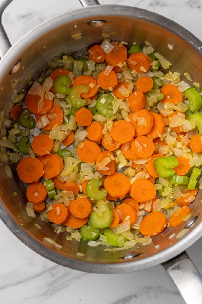 vegetable to make tomato soup combined in pot with olive oil