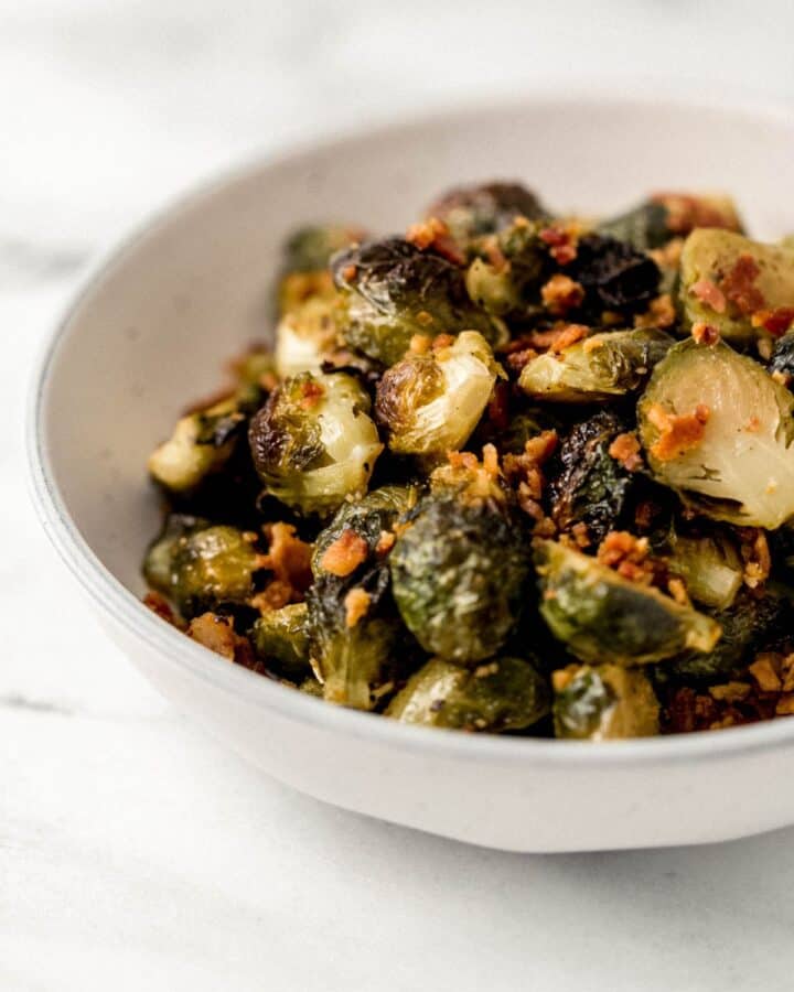 Close up side view of finished brussels in a white bowl. 