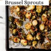 Overhead view of brussel sprouts and bacon on parchment lined baking sheet on pin with text overlay.