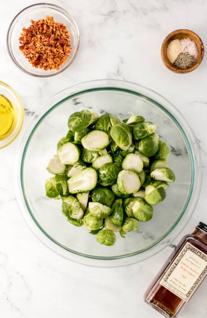 ingredients to make brussels sprouts on marble surface 