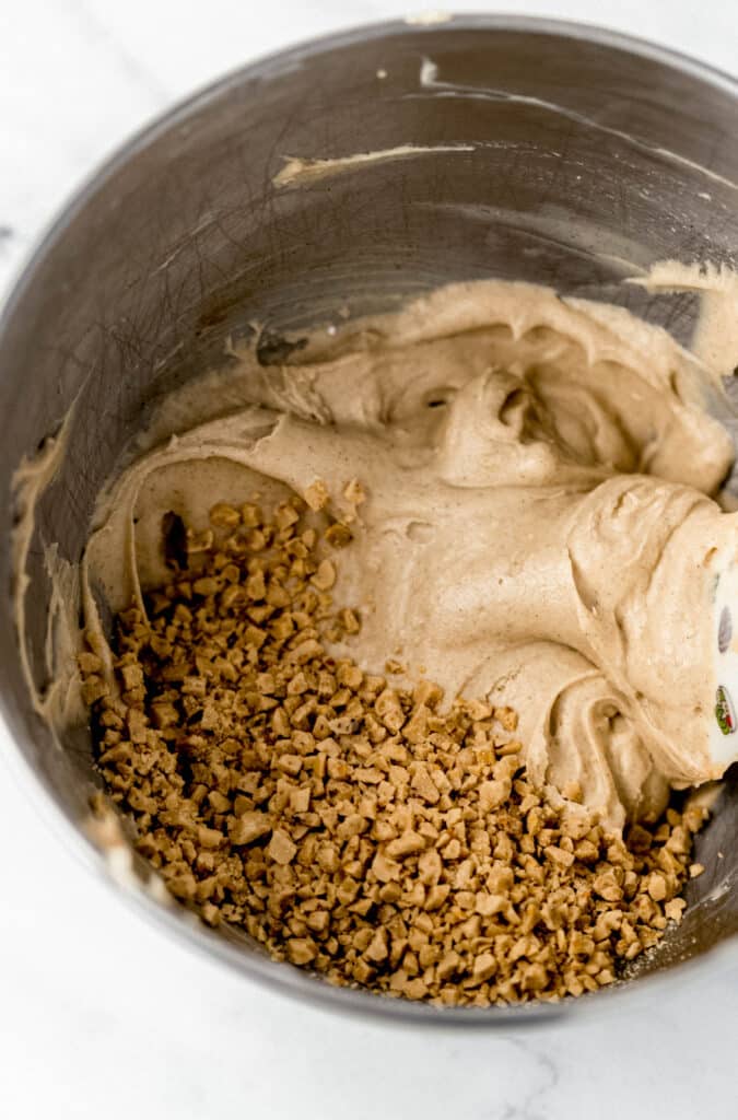 toffee bits added to snickerdoodle dip ingredients in mixer bowl 