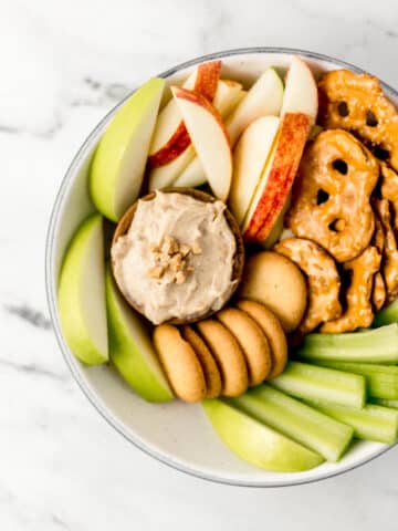 overhead view of snack bowl with small wooden bowl of toffee snickerdoodle dip