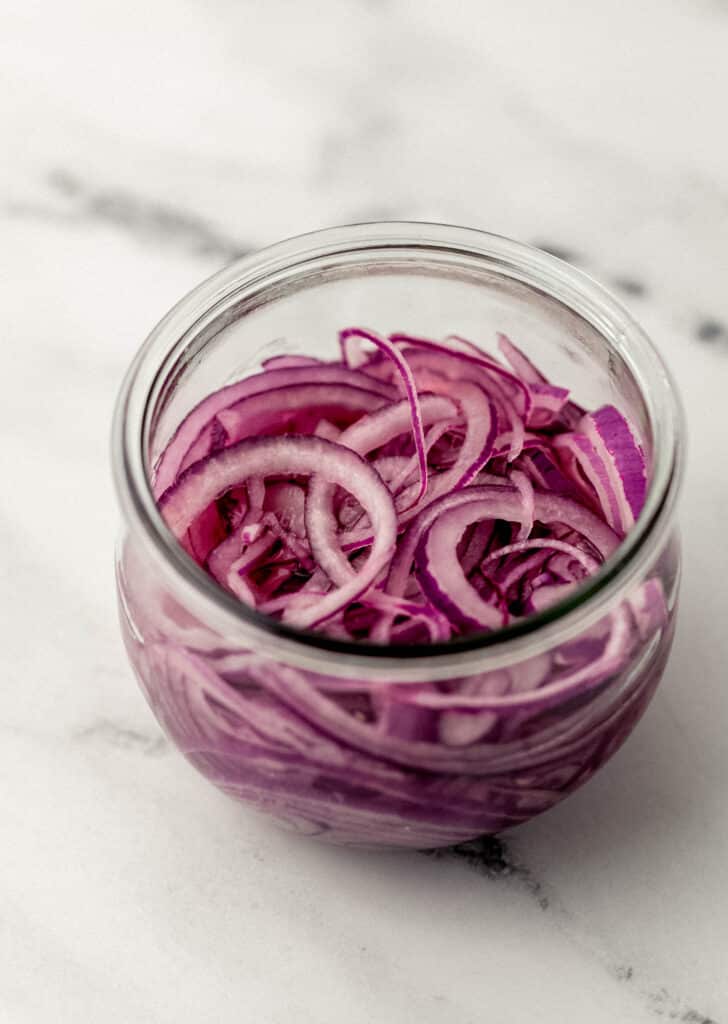 prepared pickled red onion in small open jar