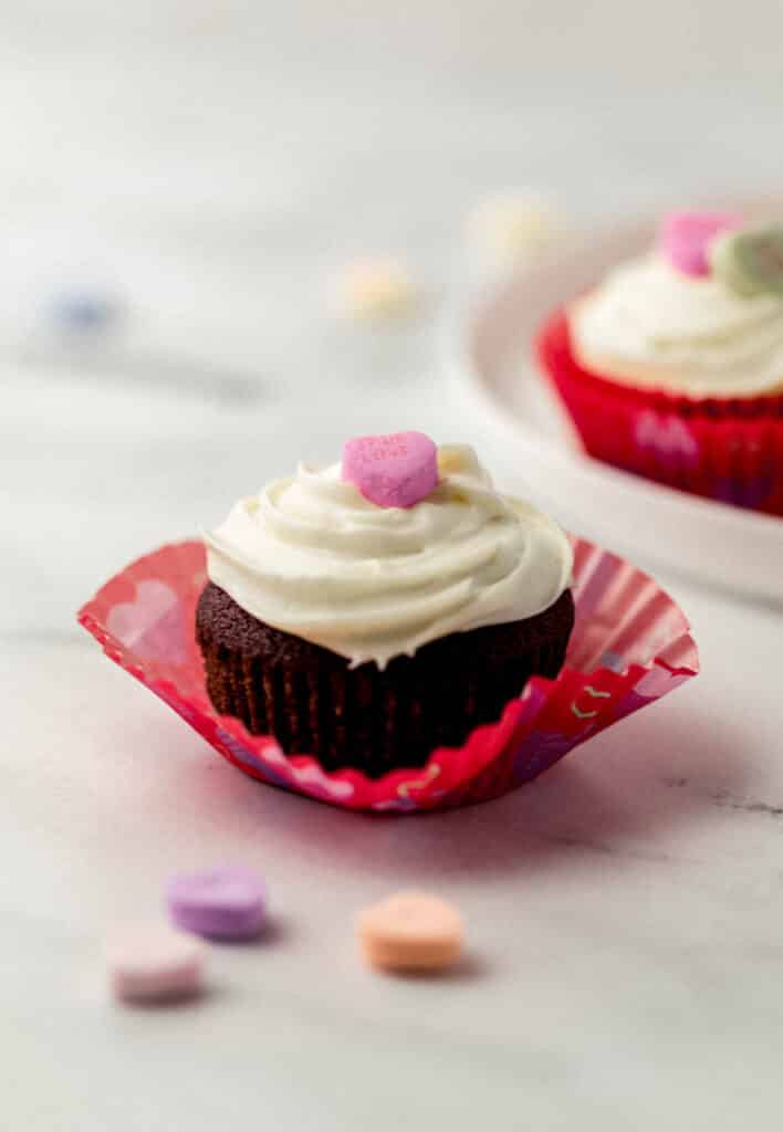 close up side view single red velvet cupcake 