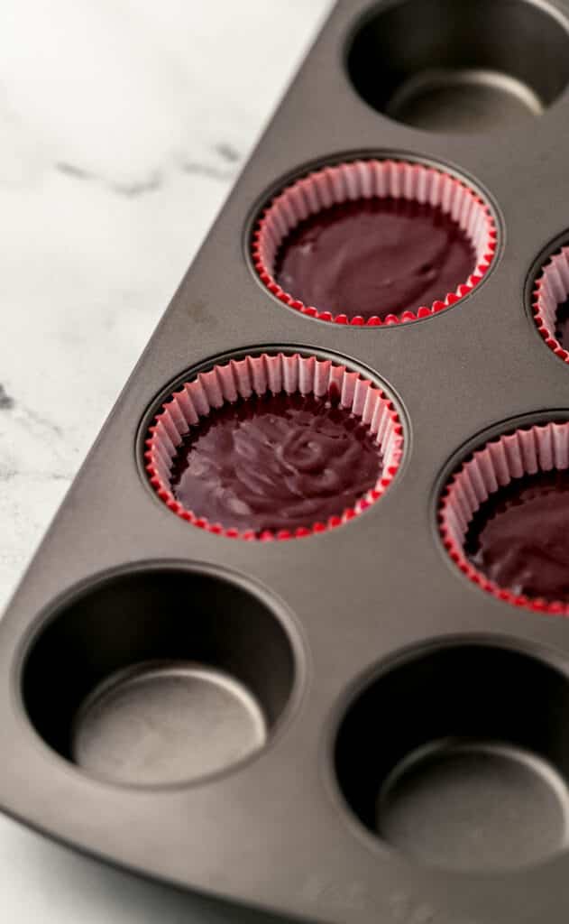 cupcake mixture added to muffin pan with liners