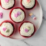 five red velvet cupcakes on white plate