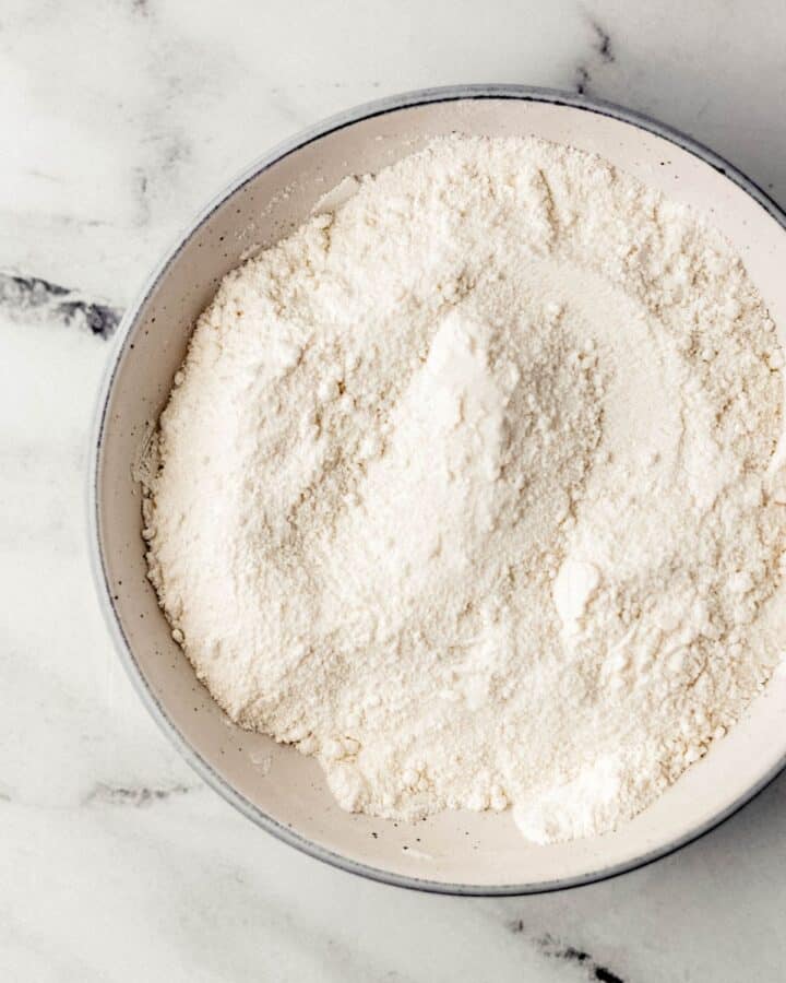 Overhead view of large bowl with dry ingredients combined in it. 