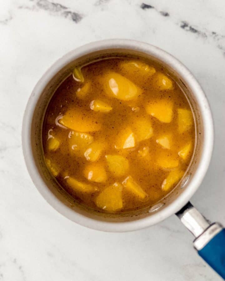Overhead view of saucepan with peach mixture in it. 