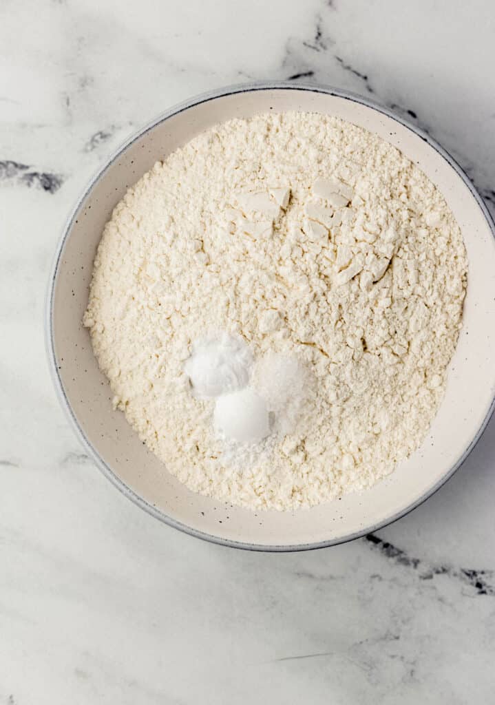 flour, salt, baking powder, and baking soda in a white bowl
