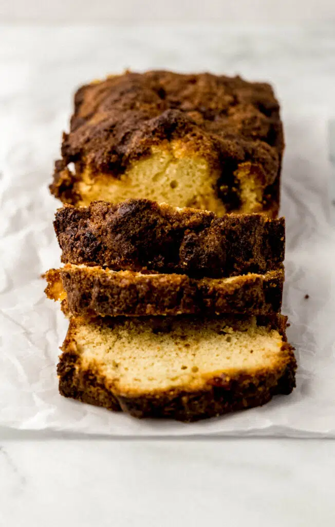 close up side view of sliced peach bread  on parchment paper