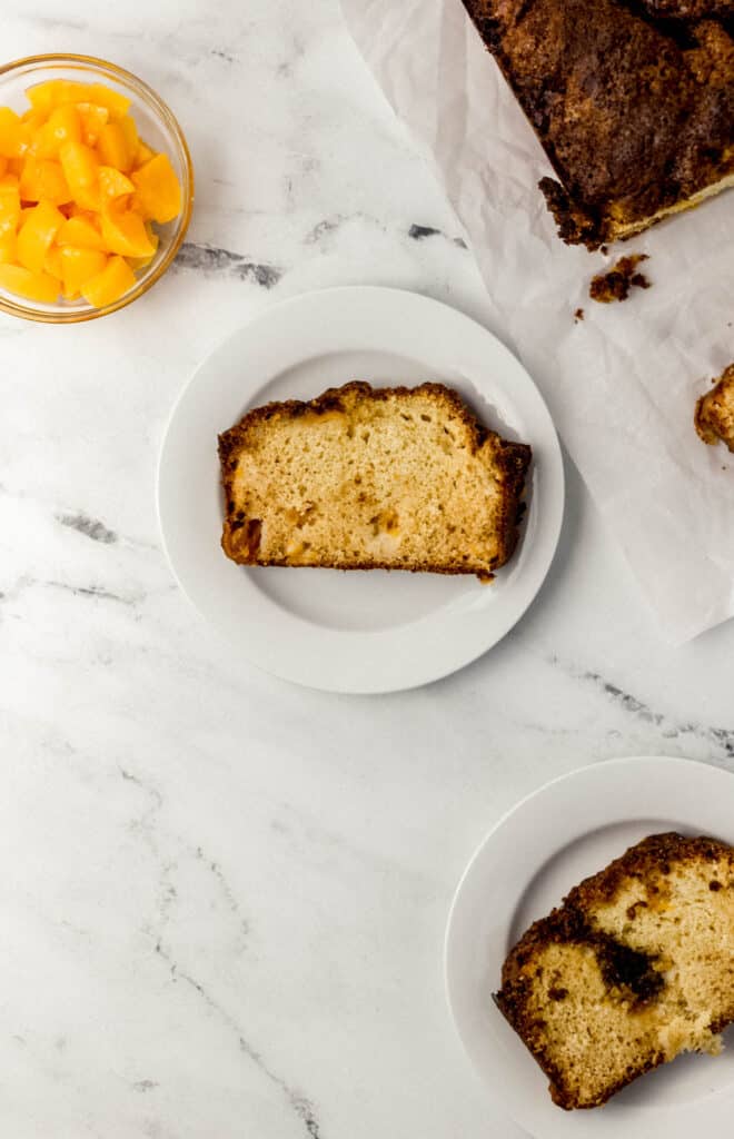 overhead view of peach bread on white place on top of marble surface