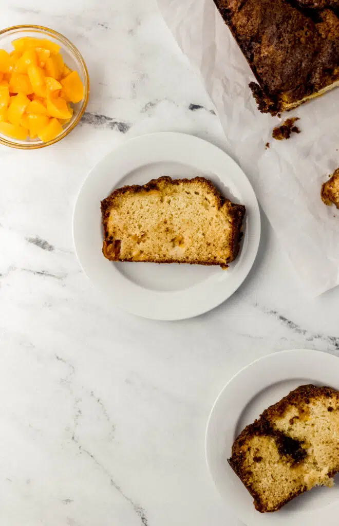 overhead view of peach bread on white place on top of marble surface