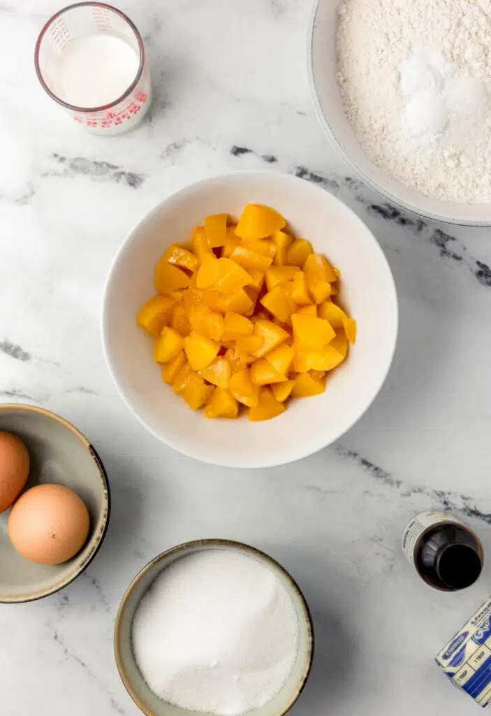 overhead view of ingredients in separate containers needed to make peach bread