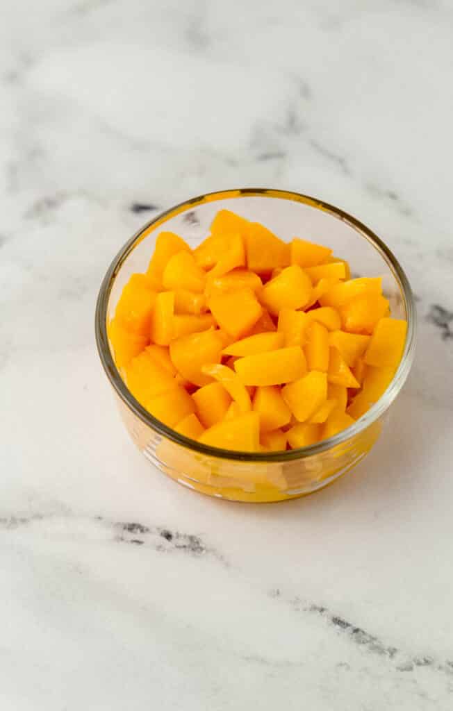 diced cling peaches in a glass bowl