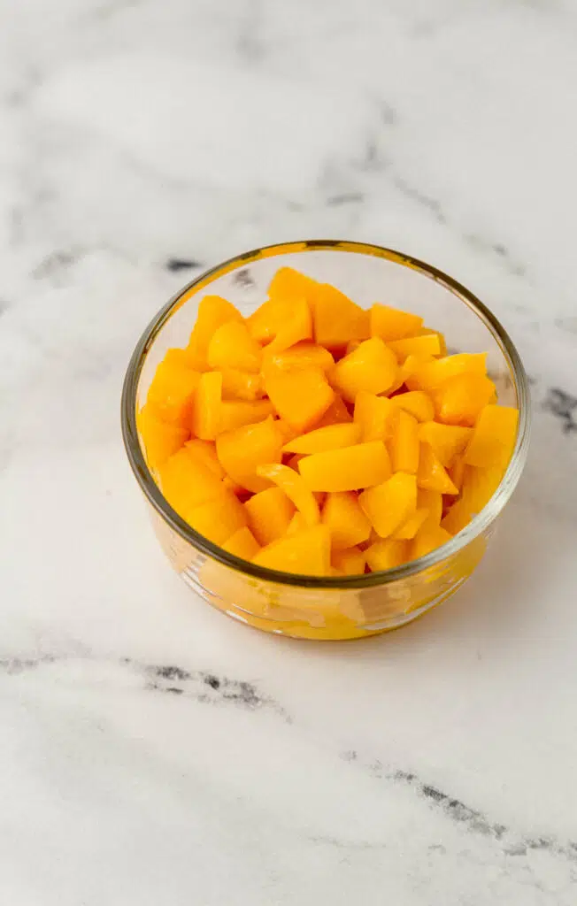diced cling peaches in a glass bowl
