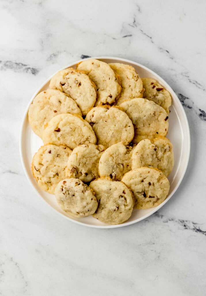 overhead view of pecan sandies on round white plate