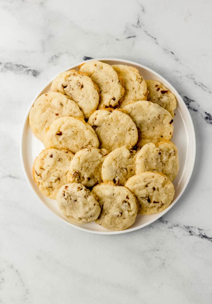 overhead view of pecan sandies on round white plate 