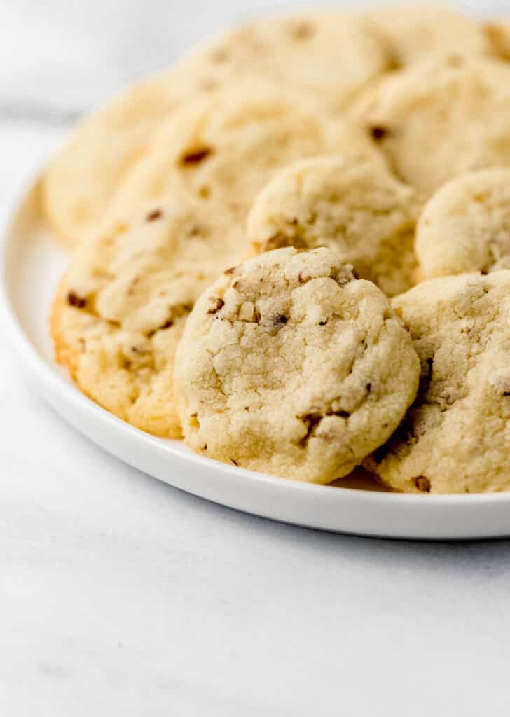 close up side view cookie on white plate 