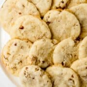 Close up photo of finished cookies on a white plate on pin with text overlay.