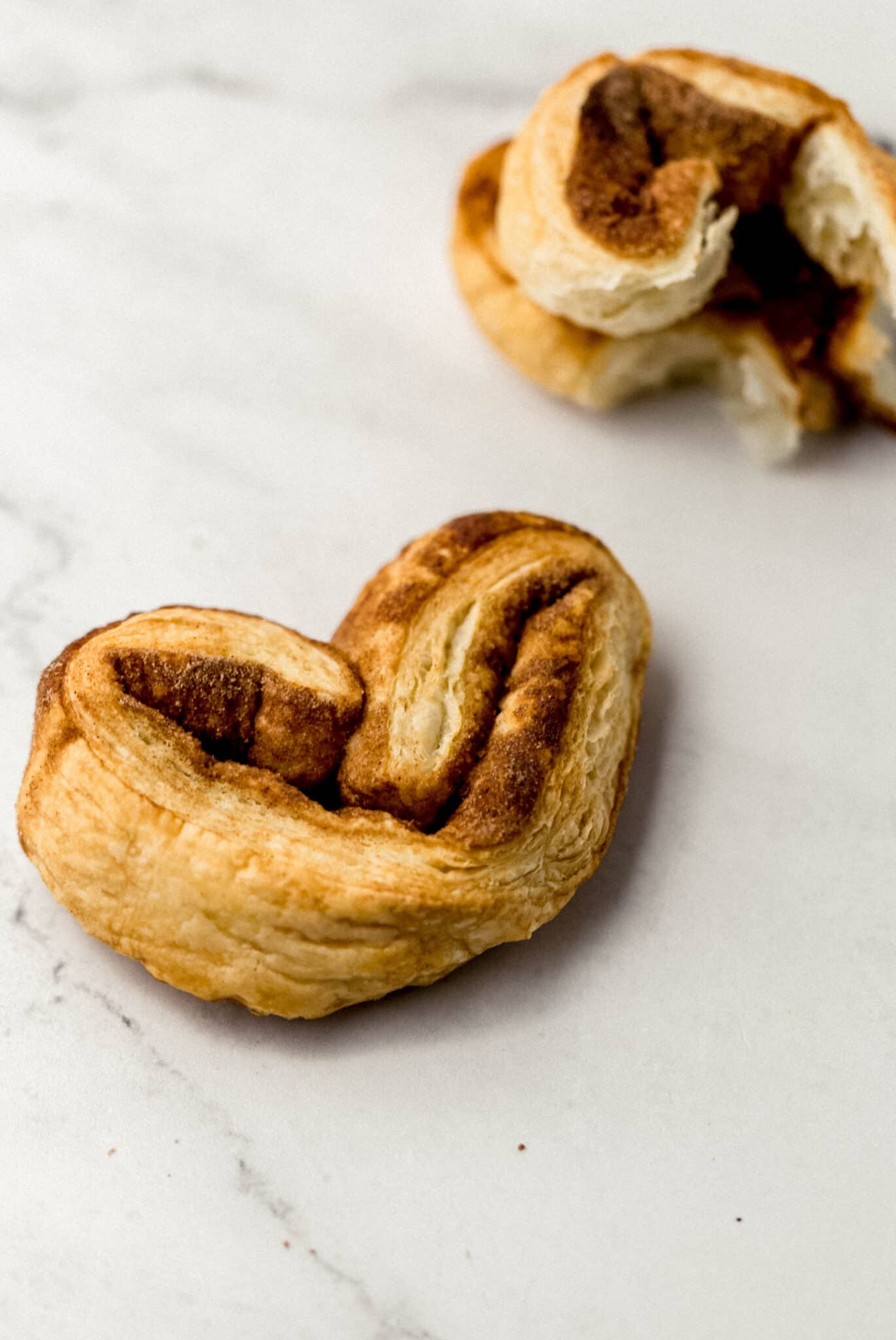 close up view of single pastry on marble surface 