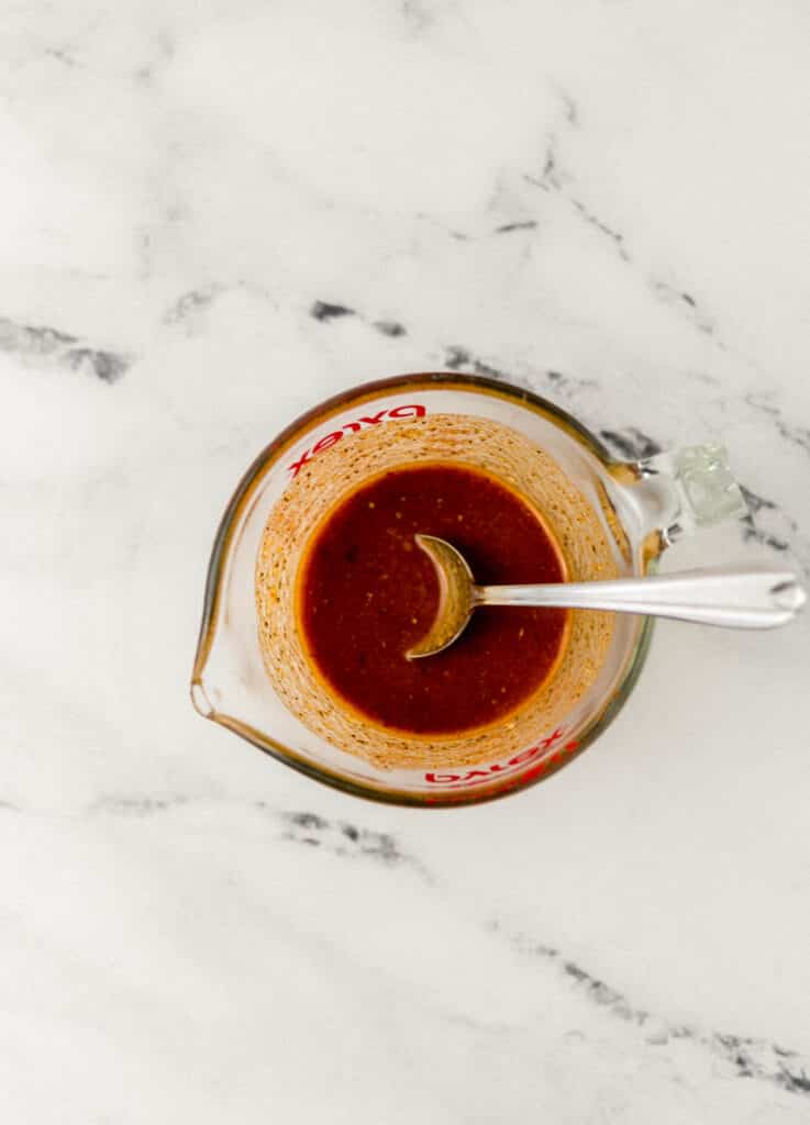 melted butter, garlic, and seasoning in small glass Pyrex pitcher with spoon