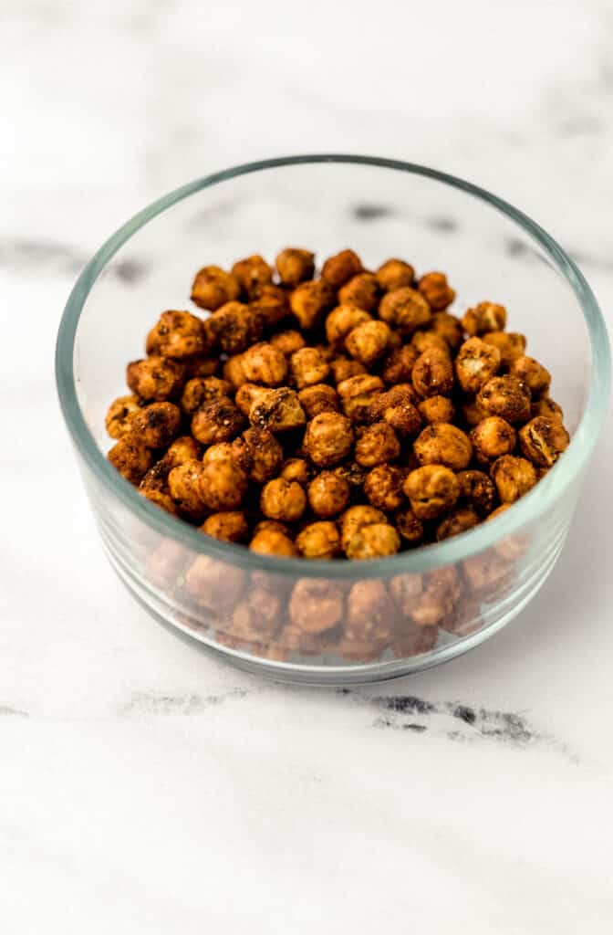 close up side view of chickpeas in a glass bowl