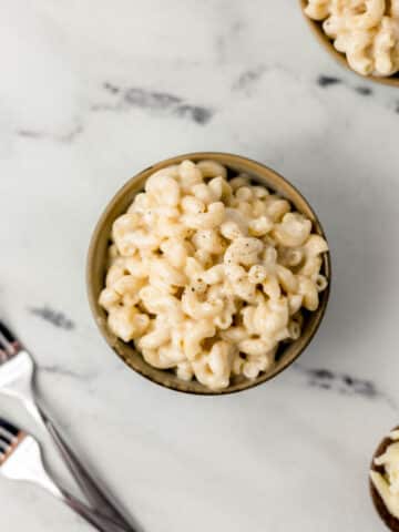 overhead view of small bowl of mac and cheese topped with black pepper