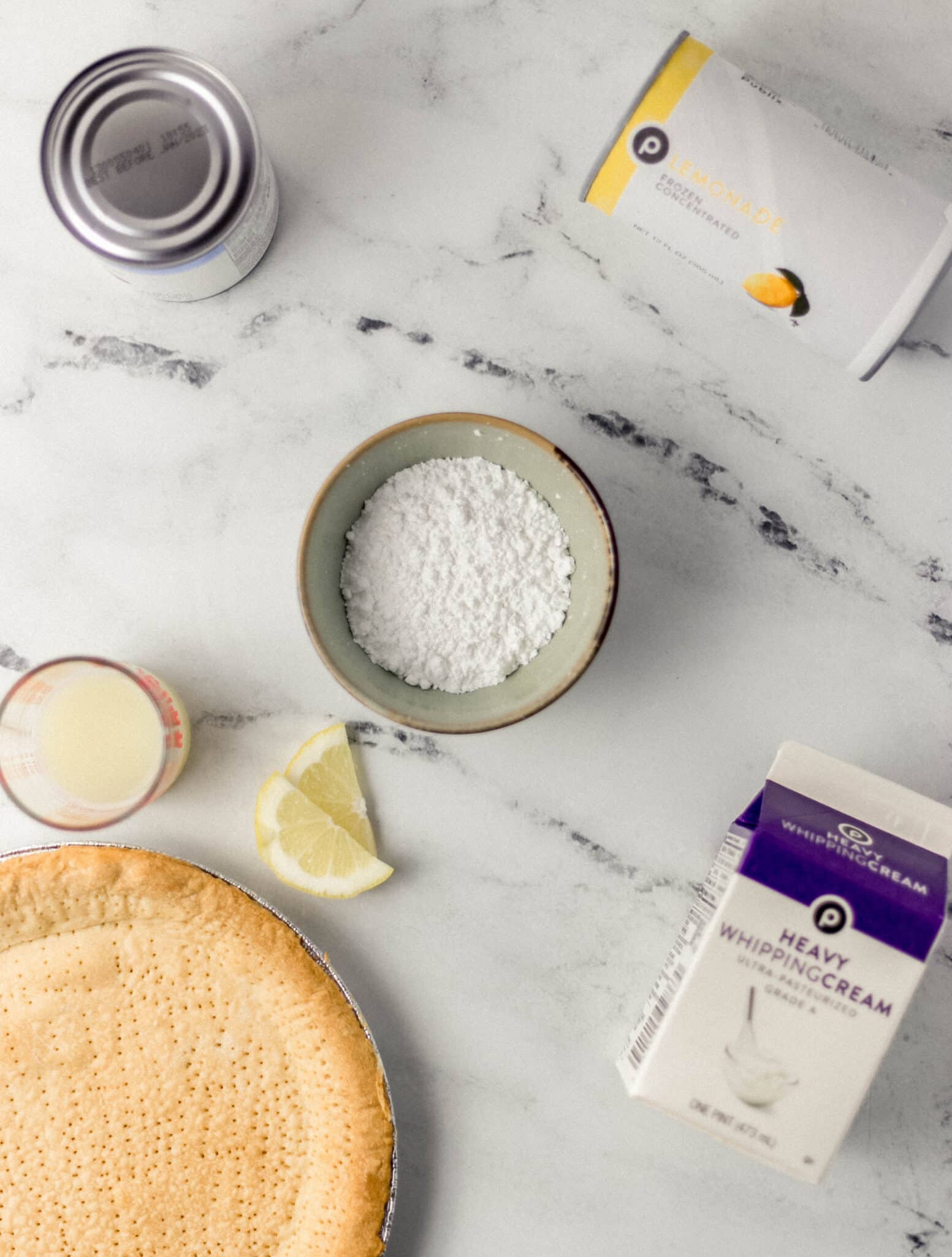 overhead view of ingredients needed to make lemonade pie in separate containers. 