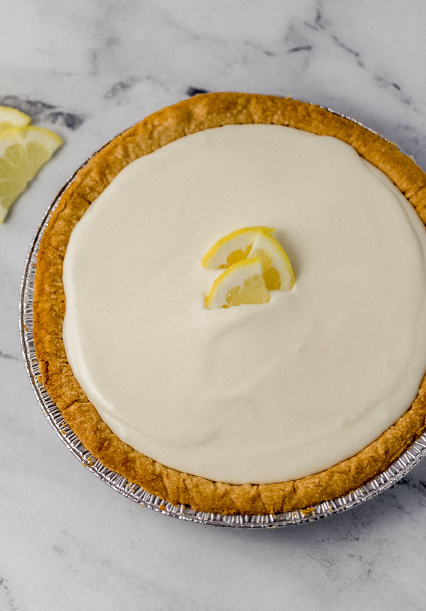 finished lemonade pit in pan topped with slices of fresh lemon
