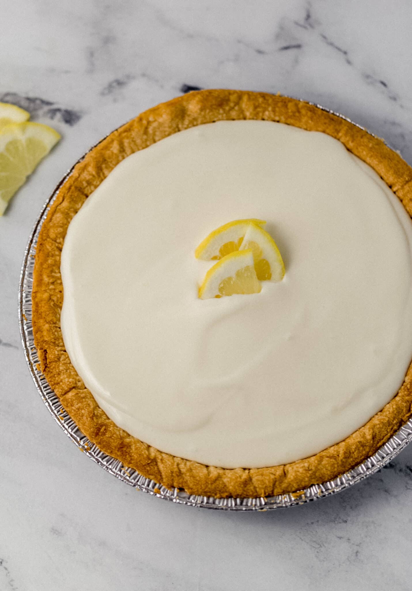 finished lemonade pit in pan topped with slices of fresh lemon 