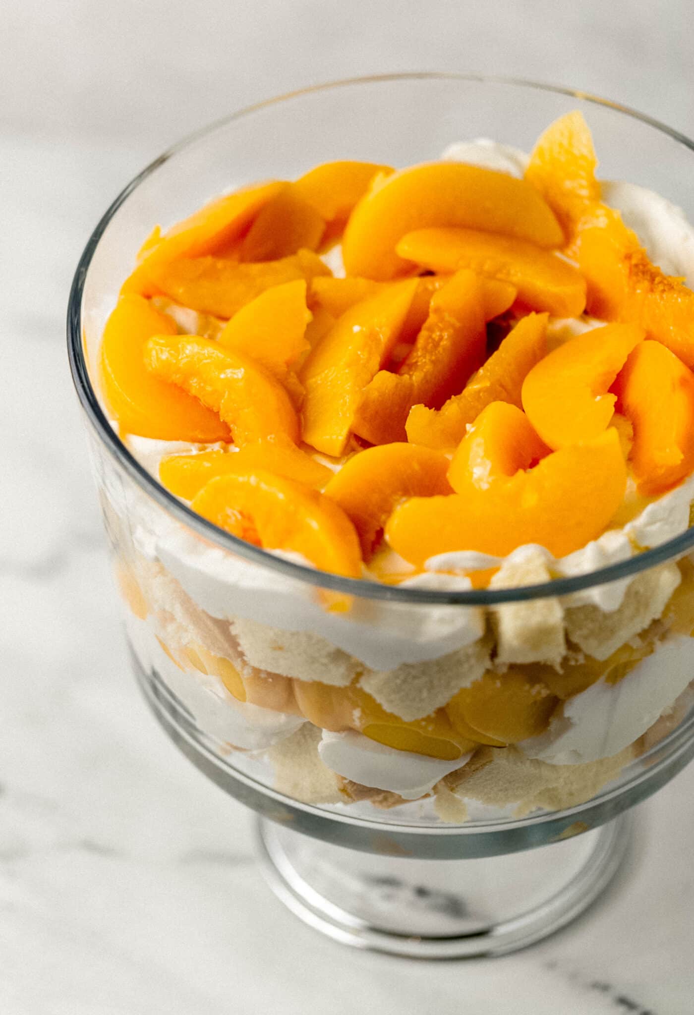 trifle topped with layer of peaches