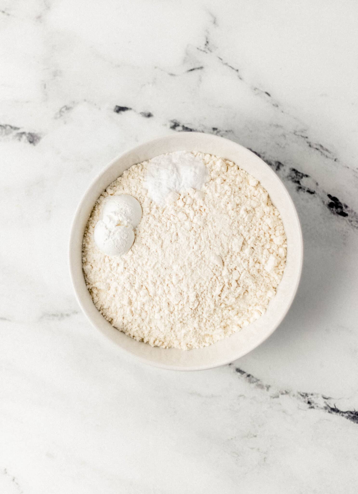 flour, cornstarch, salt, and baking soda in white bowl