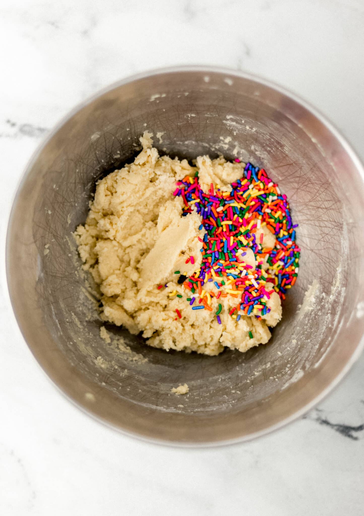 cookie dough and rainbow sprinkles in mixing bowl 