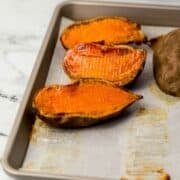 Front view of finished potatoes on parchment lined sheet pan.