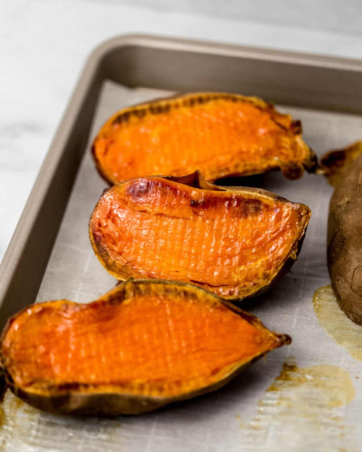 Close up view of finished potatoes on parchment lined sheet pan.