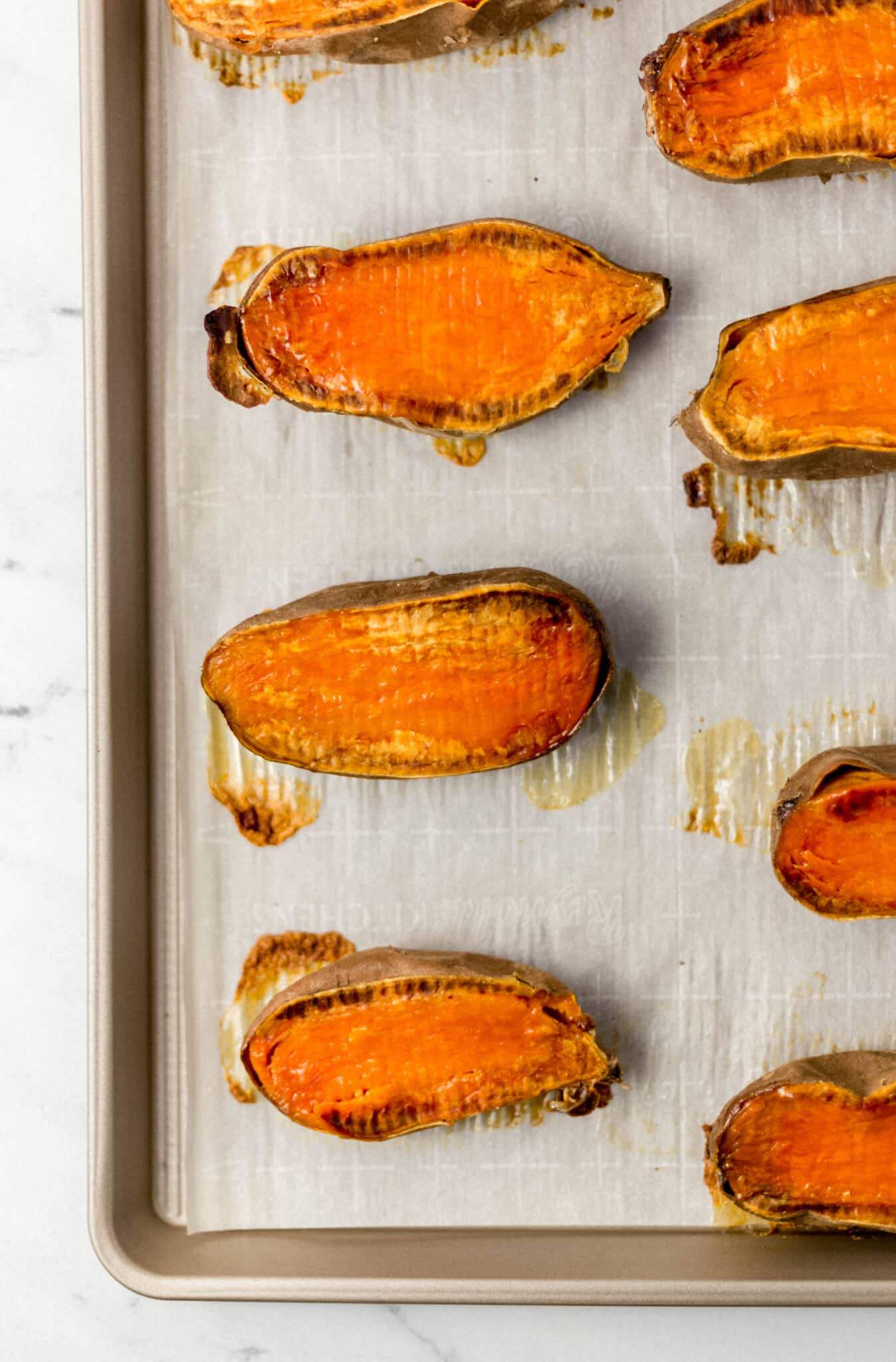 roasted sweet potato halved on sheet pan