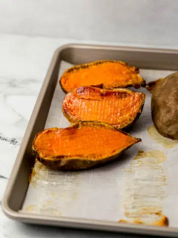 baked sweet potatoes on parchment-lined sheet pan
