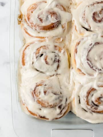 overhead view of finished cinnamon rolls in glass baking dish