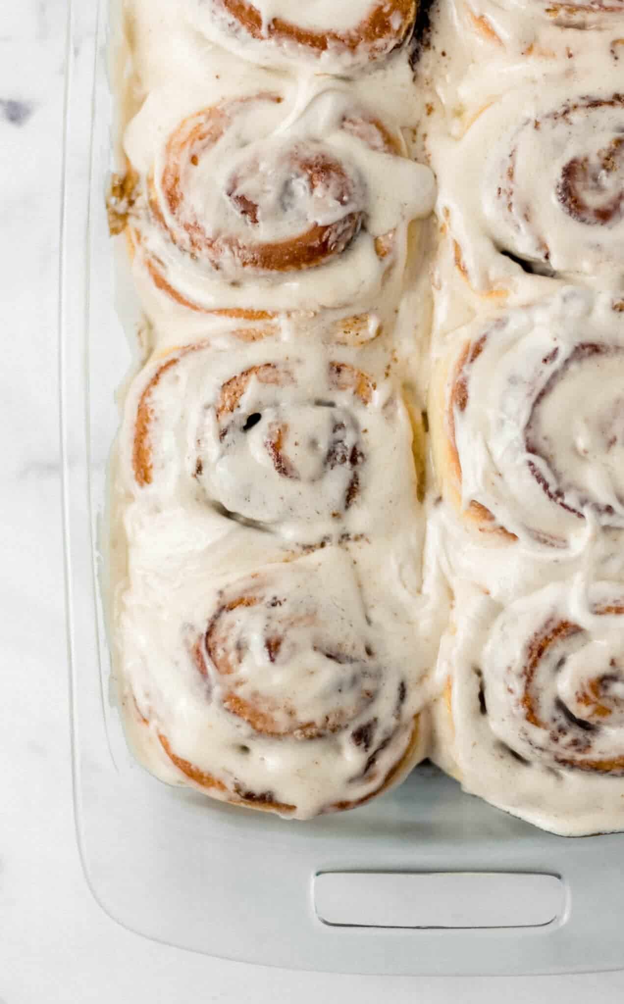 overhead view of cinnamon rolls in a glass baking dish