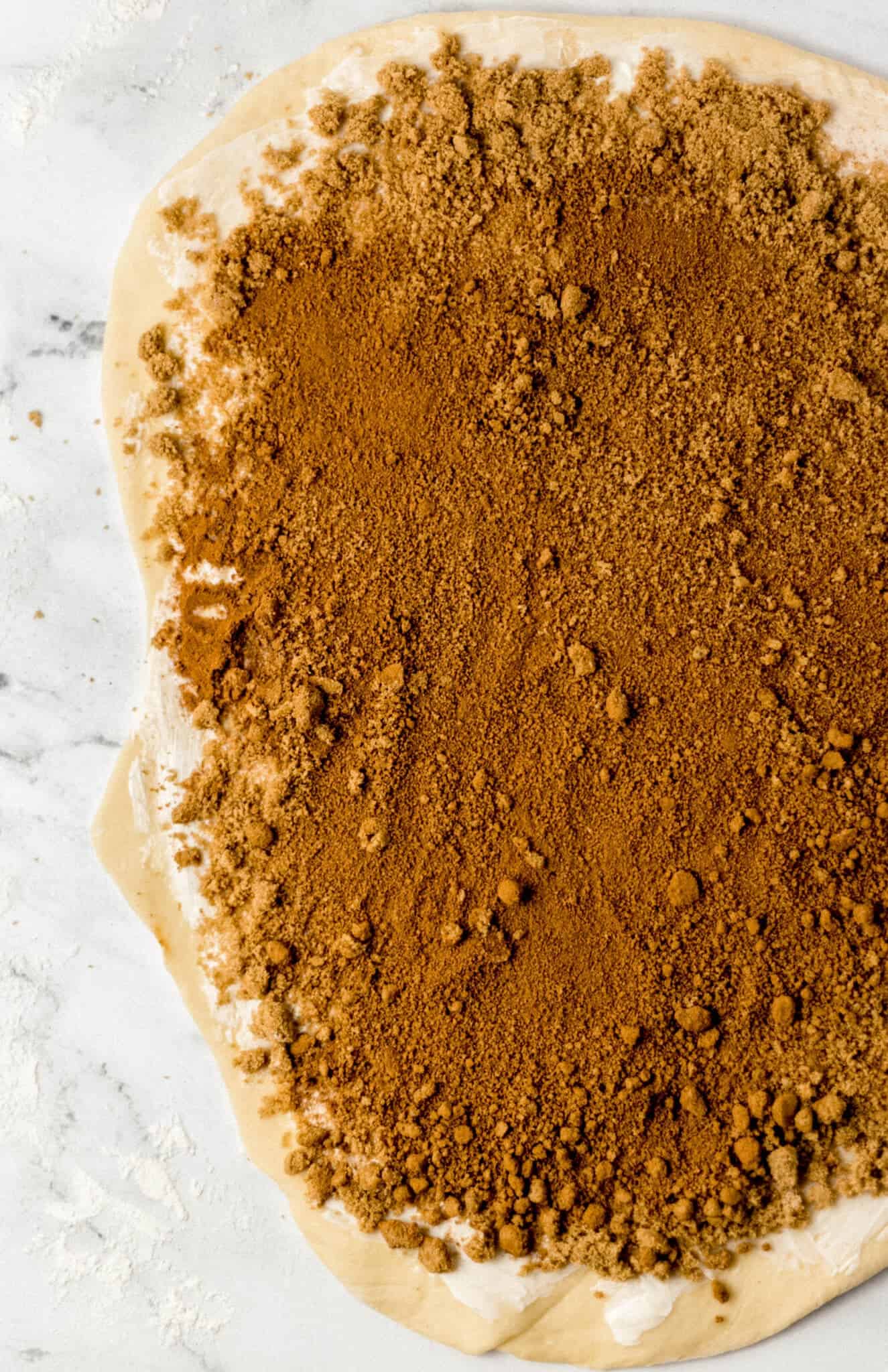 rolled out dough topped with butter, cinnamon, and brown sugar