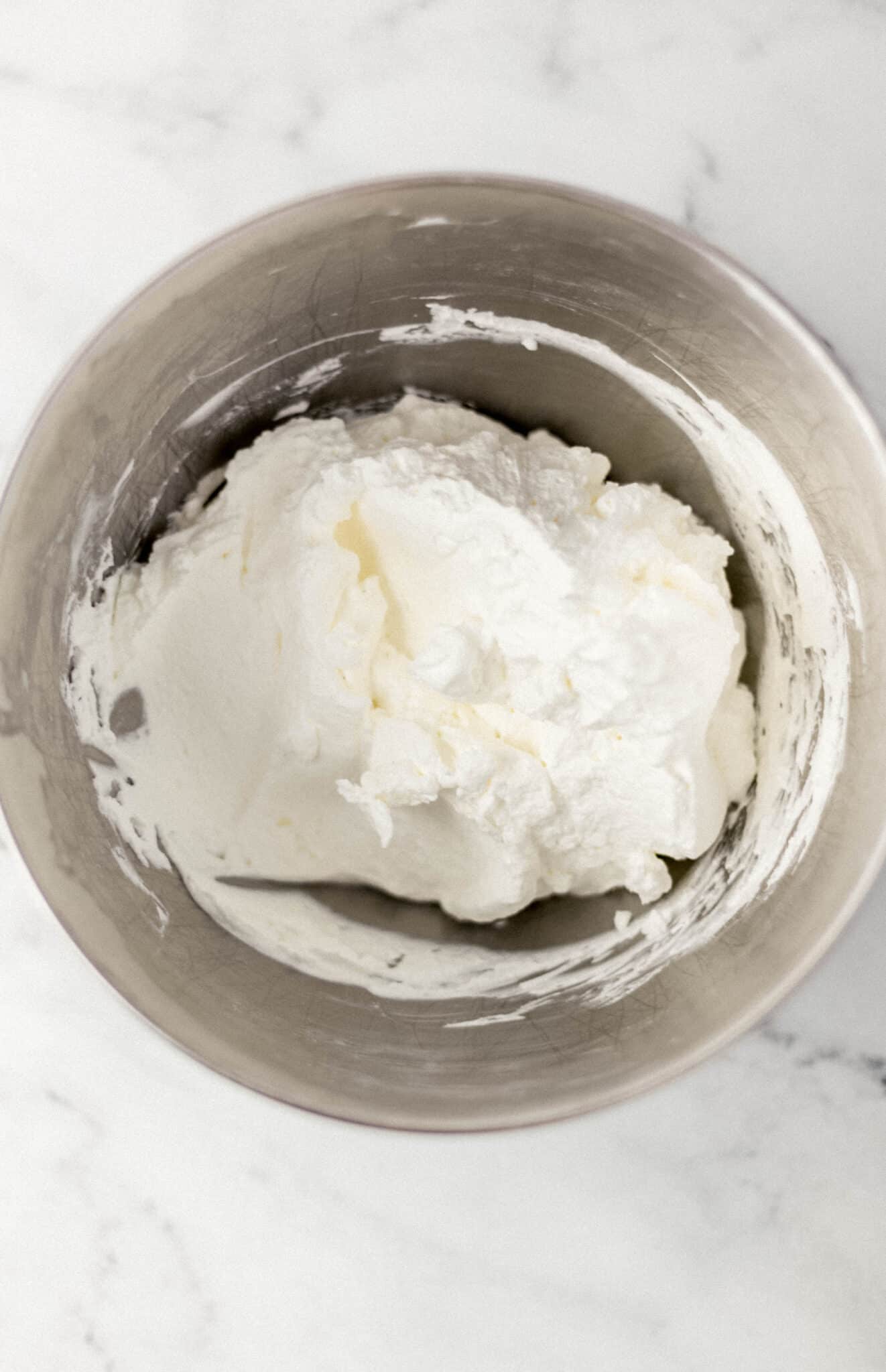 overhead view of heavy whipping cream in mixing bowl 