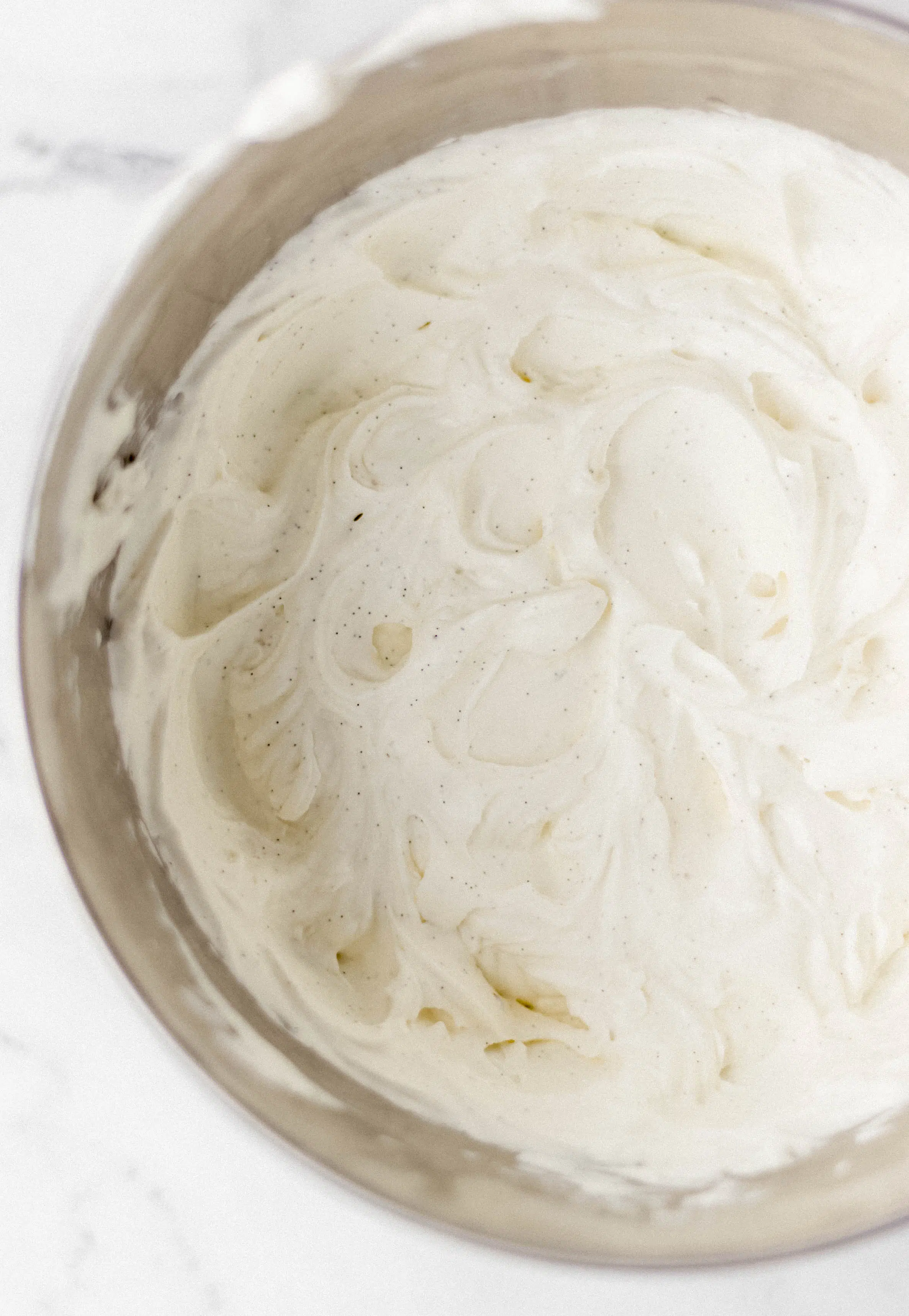 ingredients mixed together in mixing bowl to make vanilla ice cream 