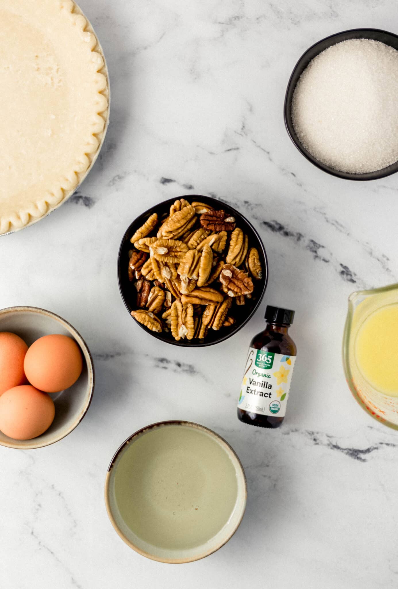 overhead view of ingredients needed to make pecan pie in separate bowls