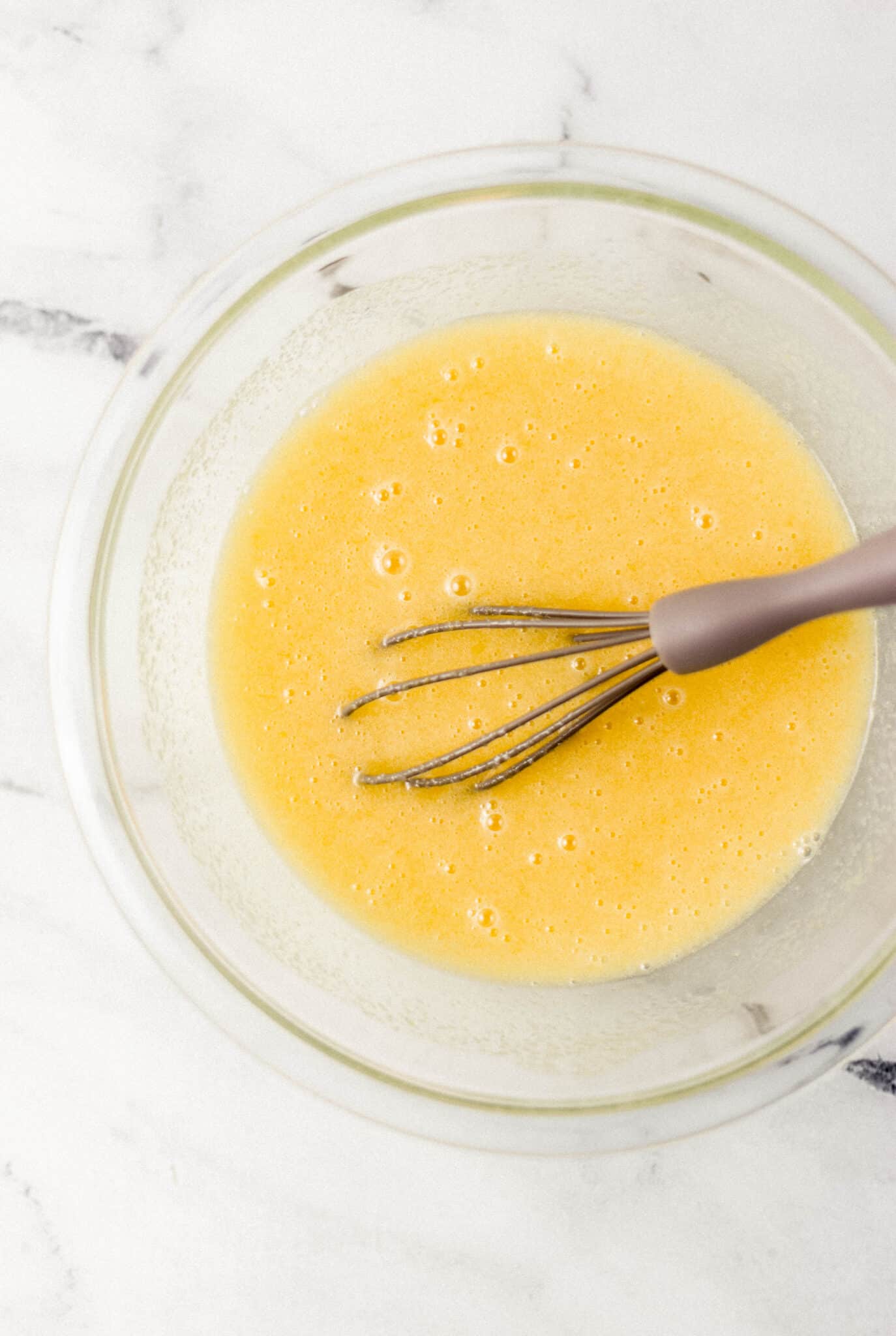 ingredients to make pie filling combined in glass mixing bowl with whisk