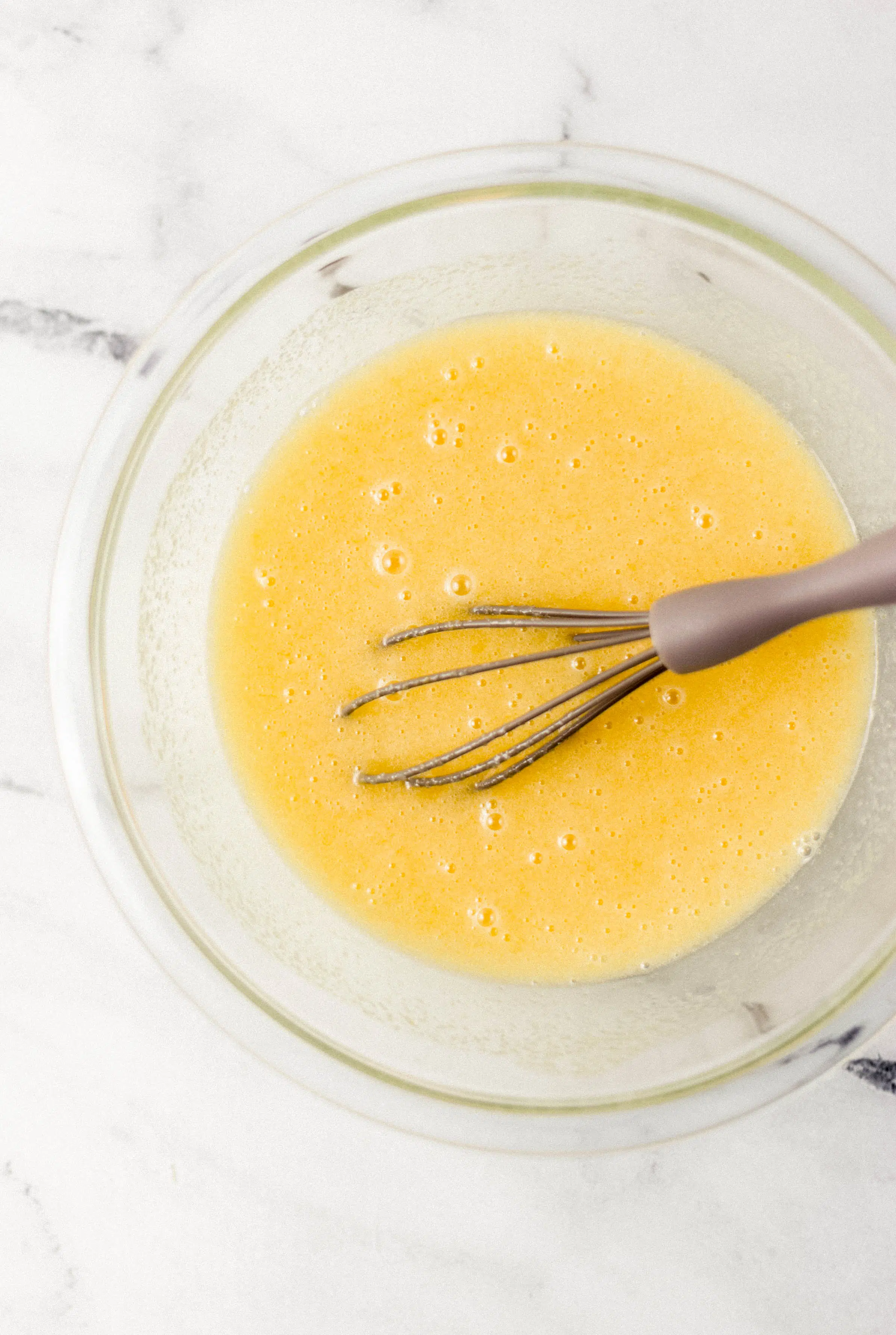 ingredients to make pie filling combined in glass mixing bowl with whisk