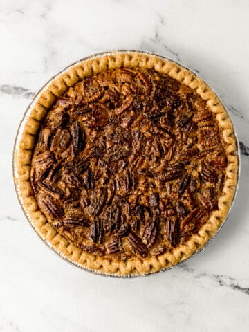 whole pecan pie on marble surface