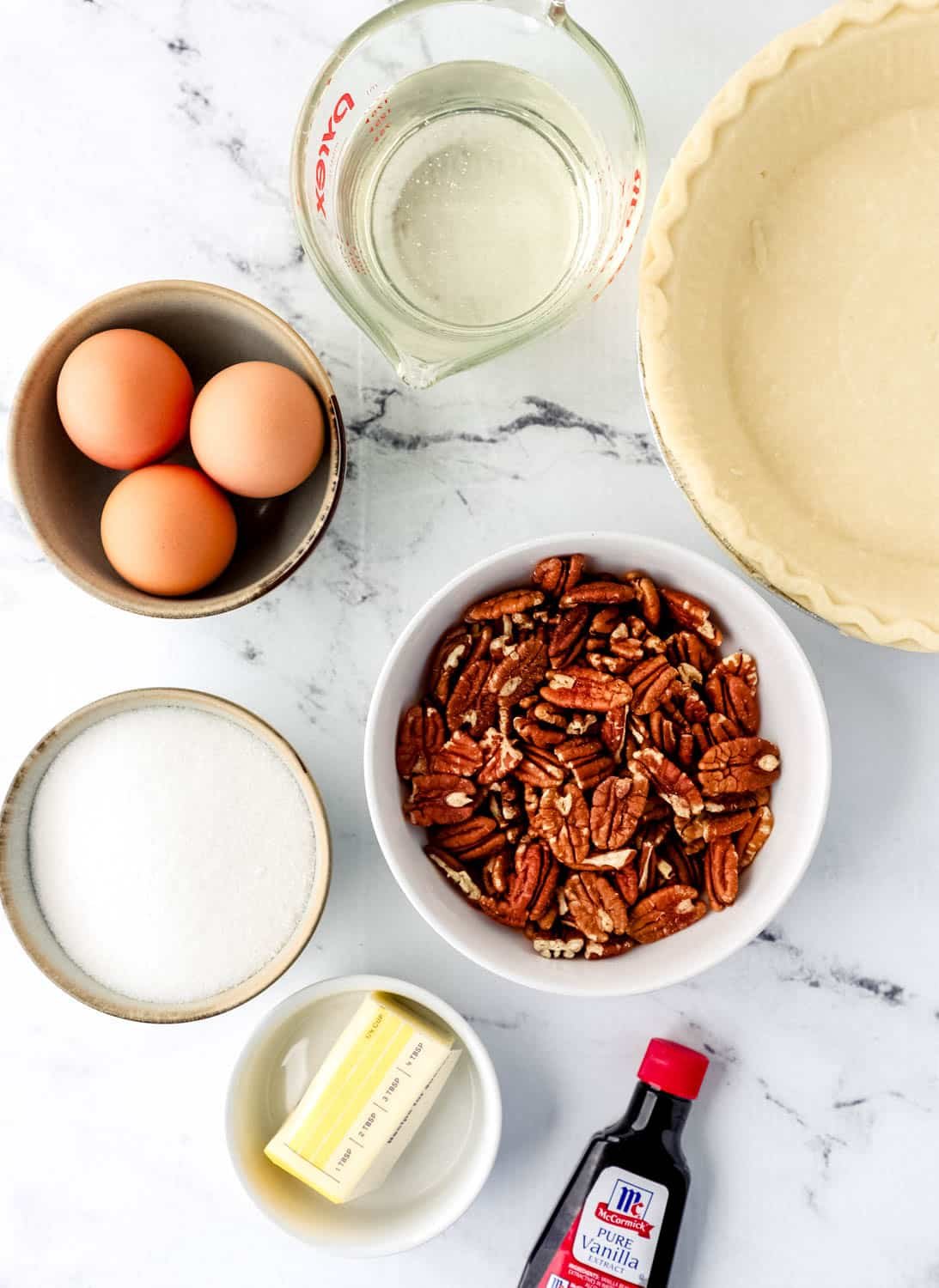 Overhead view of ingredients needed to make pie in separate bowls.