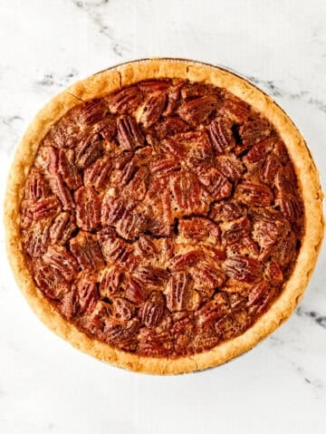 Overhead view of fully baked pie on marble surface.
